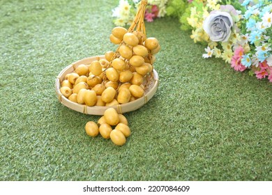 Fresh Date Plum, Yellow Sweet Desert Fruit. Date Plum Is Popular For Muslim Sweet, Laying On Green Grass.