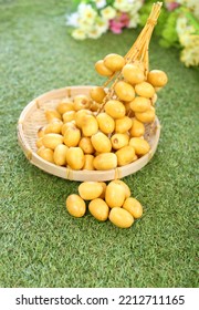 Fresh Date Plum, Yellow Sweet Desert Fruit. Date Plum Is Popular For Muslim Sweet, Laying On Green Grass.