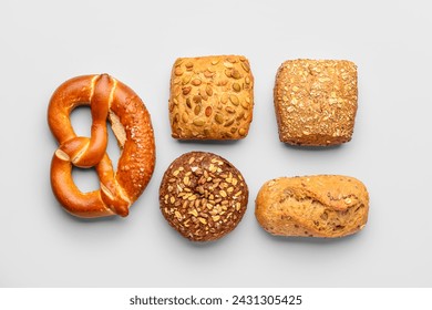 Fresh delicious buns and pretzel on white background - Powered by Shutterstock