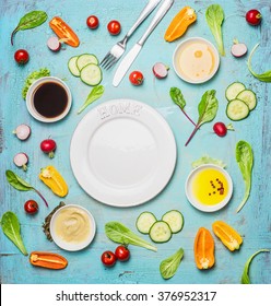 Fresh Delicious Salad And Dressing Ingredients Around Empty White Plate On Light Blue Background, Top View, Frame. Health Salad Making. Flat Lay Of Healthy  Lifestyle Or Detox Diet Food  Concept