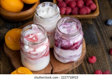 Fresh delicious yogurt made from milk with berry flavor, yogurt with fresh berries and jam