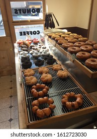 Fresh donuts awaiting customers in a donut shop.