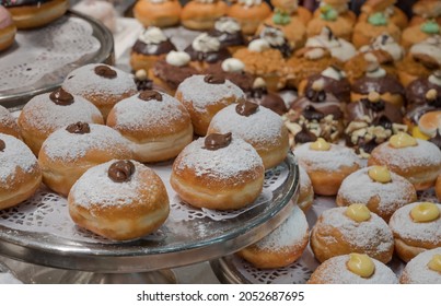 Fresh donuts with chocolate at the bakery display for Hanukkah celebration. Selective focus.