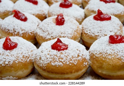 Fresh donuts with jam in the bakery for Hanukkah celebration.