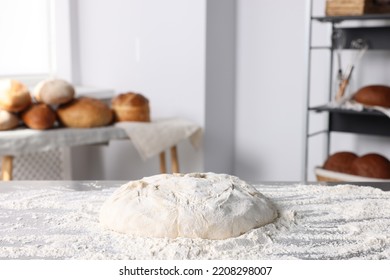 Fresh dough with flour on table in kitchen - Shutterstock ID 2208298007