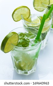 Fresh drink with lime and mint on white background