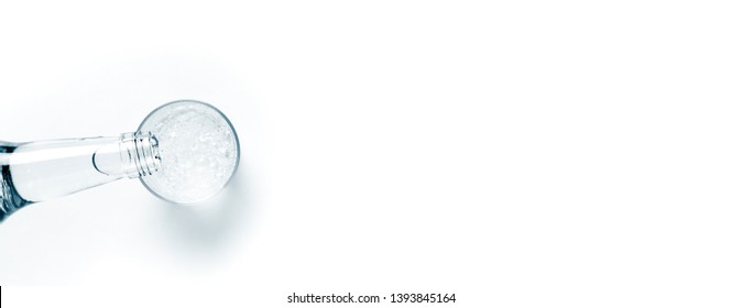 Fresh Drink Water From The Bottle And A Glass Of Sparkling Water On A White Table. Space For Text From Above. Web Banner