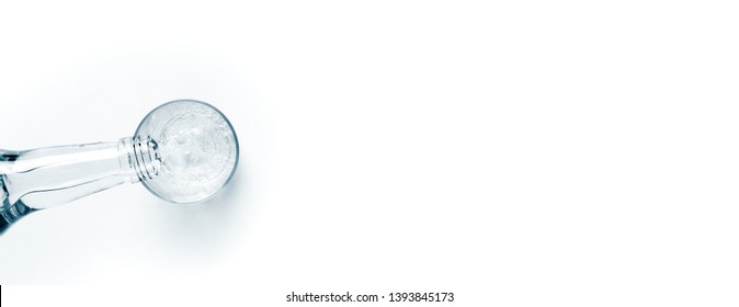 Fresh Drink Water From The Bottle And A Glass Of Sparkling Water On A White Table. Space For Text From Above. Web Banner