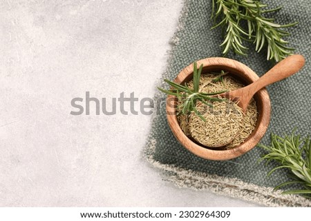 Fresh and dry rosemary on white textured table, flat lay. Space for text