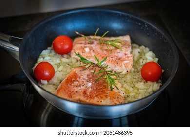 Fresh And Easy Cooking At Home - Grilled Salmon Filet In Olive Oil With Onions, Cherry Tomatoes And Rosemary