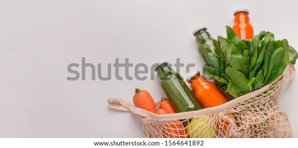 Fresh and eco.\
Detox drinks of natural components in reusable shopping bag with\
vegetables, panorama, copy\
space