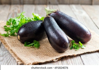 Fresh eggplant on wooden background
