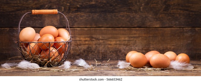 fresh eggs in a basket on wooden table.