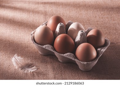 Fresh Eggs In A Cardboard Box, On A Beige Background, No People, Rustic Style, Selective Focus, Raw, Toned,sunlight,