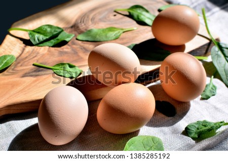 Fresh eggs on the wooden board. Keto food.