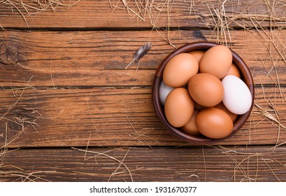 Fresh eggs from organic farms Put in a wooden bowl placed on a wooden table in the kitchen - top view.