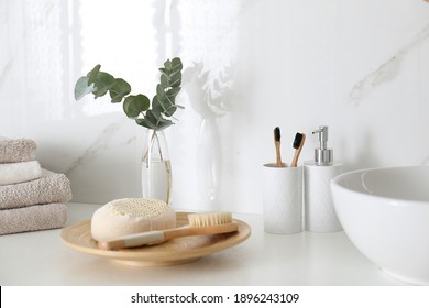 Fresh Eucalyptus Branches And Bathroom Items On Countertop