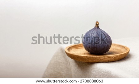 Fresh fig on a light background. Healthy and exotic fruit on a table with linen tablecloth.