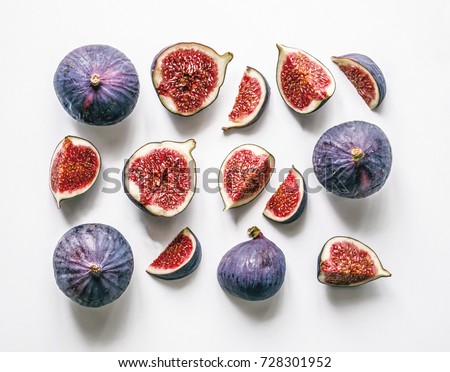 Fresh figs. Food Photo. Creative scheme of the whole and sliced figs on a white background, inscribed in a rectangle. View from above. Copy space
