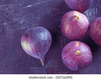 Fresh Figs On A Dark Purple Table.  Top View. Close-up 