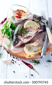 Fresh Fish With Aromatic Herbs, Spices, Salt, Saucers With Olive Oil, Perch On Slate Tray On A Wet Dock, On White Vintage Background, Top View, Healthy Food, Diet Or Cooking Concept