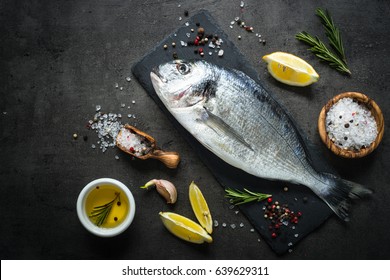 Fresh Fish Dorado. Dorado And Ingredients For Cooking At Black Slate Table. Top View With Copy Space.