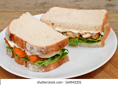 Fresh Fish Finger Sandwich On A White Serving Plate