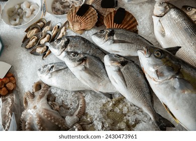 Fresh fish and seafood counter on market. A variety of different seafood on ice, at the fish market in Finland - Powered by Shutterstock