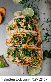 Fresh Fish Tacos With  Lettuce, Tomato, Onion, Avocado, Garnished With Slices Of Lime And Lots Of Cilantro