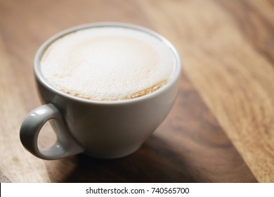 fresh flat white coffee on wood table