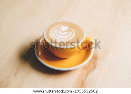 Fresh flavored coffee art is on the wooden table.