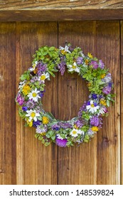 Fresh Flower Wreath At The Door Of An Old Hut