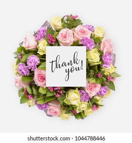 Fresh flowers bunch and card with words thank you written on it