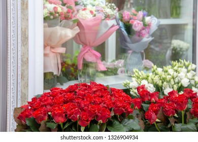 Fresh Flowers - Red Roses And White Eustomas - In Front Of A Floristry Shop Window, Where Elegant Delicate Bouquets Stand In Anticipation Of A Buyer. Small Business. Floral Design Studio