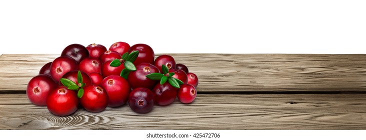 Fresh Forage Cranberries With Leaves On Wooden Table. Clipping Paths, Infinite Depth Of Field