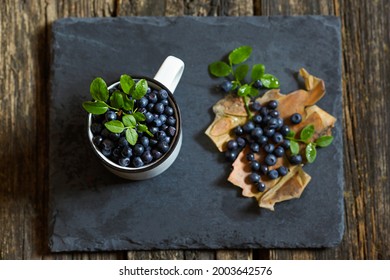 Fresh Forest Blueberries On A Dark Background. View From Above. Collection Of Blue And Black Berries. Healthy Food Concept.