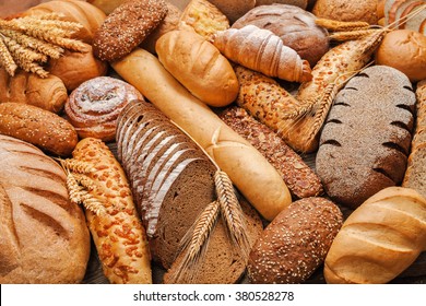 Fresh fragrant bread on the table. Food concept - Shutterstock ID 380528278