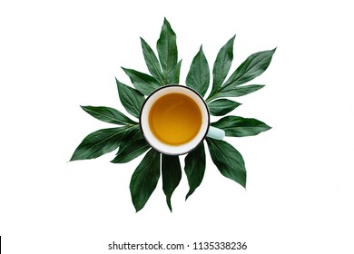 Fresh Fragrant And Useful Herbal Or Green Tea In A Mug With Plant Leaves Isolated On White Background