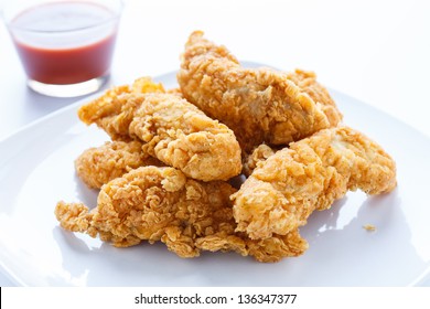 Fresh, Fried Chicken Strips On A White Plate In Natural Light