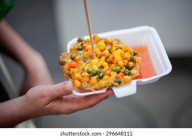 Fresh Fried Corn, Peas And Carrot Fritter Tod Man Khao Pod. Traditional Thai Street Food Cuisine In Hand