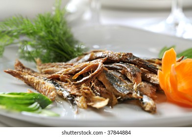 Fresh Fried European Anchovy On A White Plate