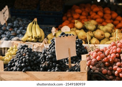 Fresh fruit at a farmer's market. A variety of colorful grapes, bananas, plums, and pears are displayed in wooden crates. Perfect for themes of healthy eating, abundance, and freshness. - Powered by Shutterstock