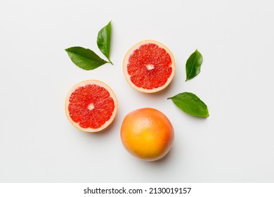 fresh Fruit grapefruit with Juicy grapefruit slices on colored background. Top view. Copy Space. creative summer concept. Half of citrus in minimal flat lay with copy space.
