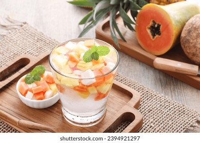 Fresh fruit ice containing pieces of papaya, pineapple and jicama with sweet and sour sauce - Shutterstock ID 2394921297
