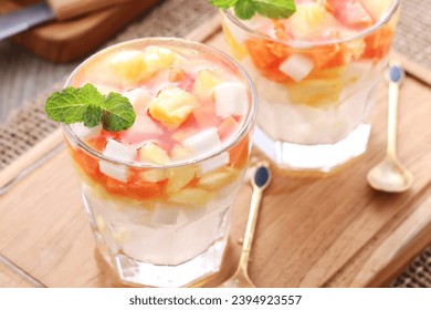 Fresh fruit ice containing pieces of papaya, pineapple and jicama with sweet and sour sauce - Shutterstock ID 2394923557