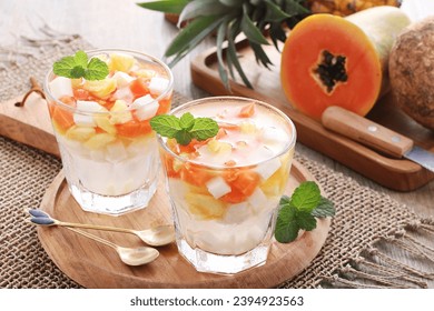 Fresh fruit ice containing pieces of papaya, pineapple and jicama with sweet and sour sauce - Shutterstock ID 2394923563