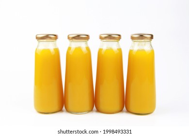 Fresh Fruit Juice In Small Glass Bottles On A White Background.Empty Front Area For Branded Labels For Beverage Design.Orange Juice,mango, Mandarin, Apricot,peach,persimmon, Pumpkin, Sea Buckthorn