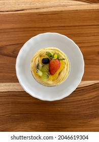 Fresh Fruit Pie Tart With Kiwi, Blueberry, Orange And Strawberry In White Plate On Wooden Background