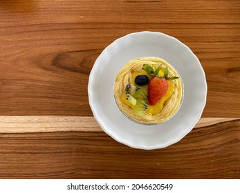 Fresh Fruit Pie Tart With Kiwi, Blueberry, Orange And Strawberry In White Plate On Wooden Background