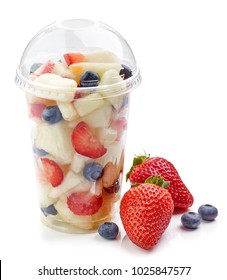 Fresh Fruit Pieces Salad In Plastic Cup Isolated On White Background